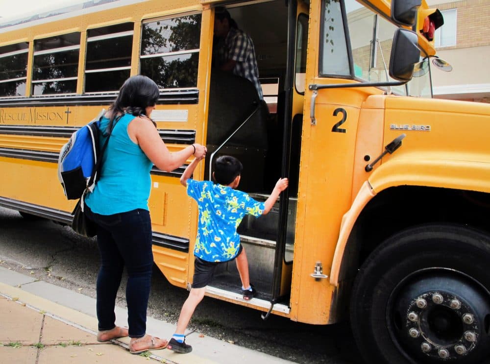 Social service advocates and their family members board a bus in Albuquerque, N.M., on July 17, 2015, for a public hearing in Santa Fe where they planned to speak against New Mexico's proposal to impose work and job training requirements for low-income New Mexicans who receive food stamps. (Susan Montoya Bryan/AP)