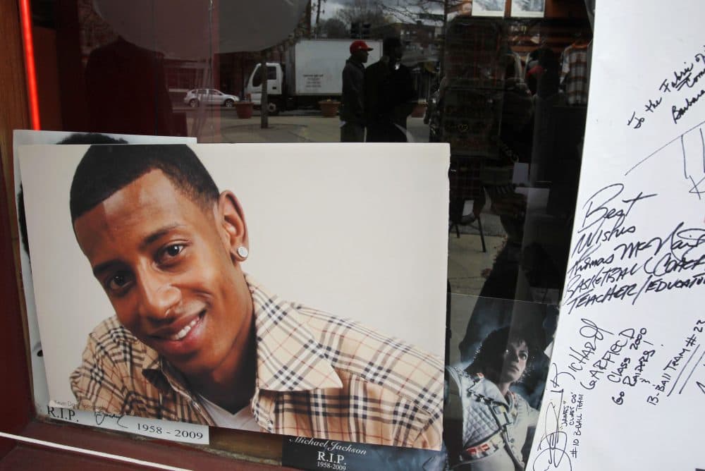A photograph of D.J. Henry, who was shot and killed by a New York police officer in 2010, is seen in the window of a radio station in Boston's Roxbury neighborhood in 2011. (Steven Senne/AP)
