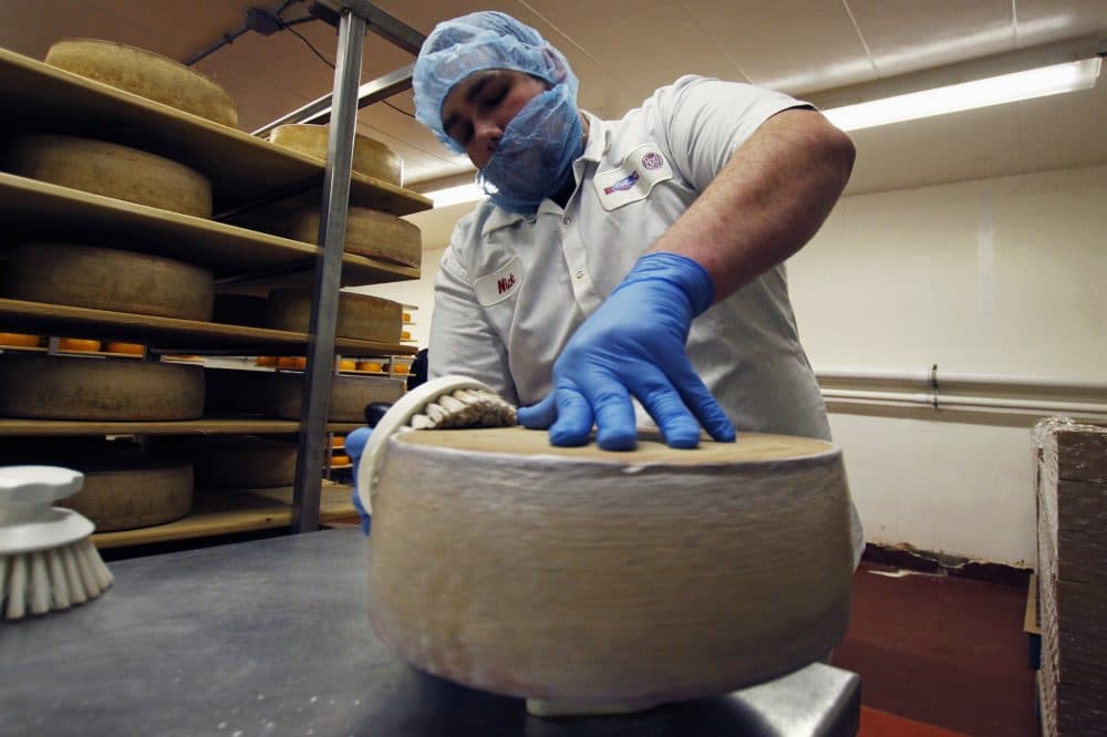 In this Feb. 27, 2017, photo, Nick Brummel prepares a wheel of Grand Cru Surchoix cheese at the Emmi Roth USA production plant in Monroe, Wis, for labeling. The company won the World Championship Cheese Contest in 2016 for the cheese and since then has seen an increase in sales of the cheese. The contest is organized by the Wisconsin Cheese Makers Association, which also organizes the United States Championship Cheese Contest that runs until March 9, in Green Bay, Wis. The contests are in alternate years. (AP Photo/Carrie Antlfinger)