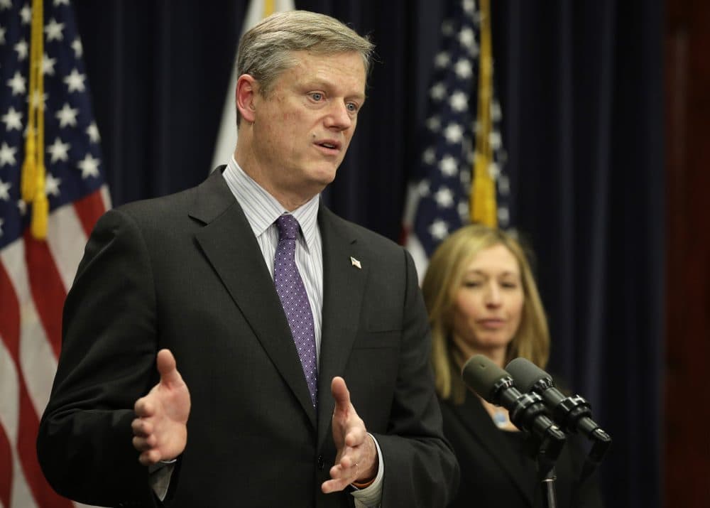 Gov. Charlie Baker takes questions from members of the media as Secretary of Administration and Finance Kristen Lepore looks on during a January news conference. (Steven Senne/AP)