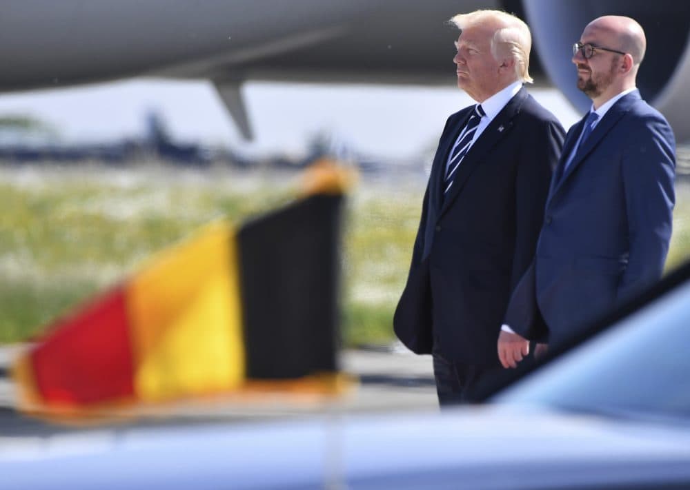 Trump was overseas when the White House released its budget proposal and a suicide bomber attacked a concert in Manchester, England. All that and more from Tom Keane’s weekly news roundup. Pictured: President Donald Trump stands with Belgian Prime Minister Charles Michel during the playing of National Anthems in Melsbroek, Belgium on Wednesday, May 24, 2017. (Geert Vanden Wijngaert/AP)