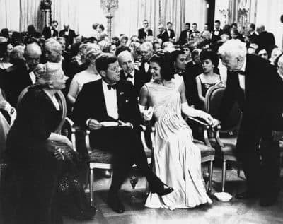 President John F. Kennedy and his wife Jacqueline, look on as poet Robert Frost, right, takes his seat in the East Room of the White House on April 30, 1962. (AP)
