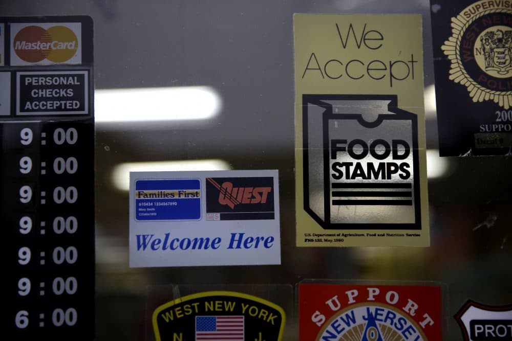 A supermarket displays stickers indicating they accept food stamps. (Seth Wenig/AP)