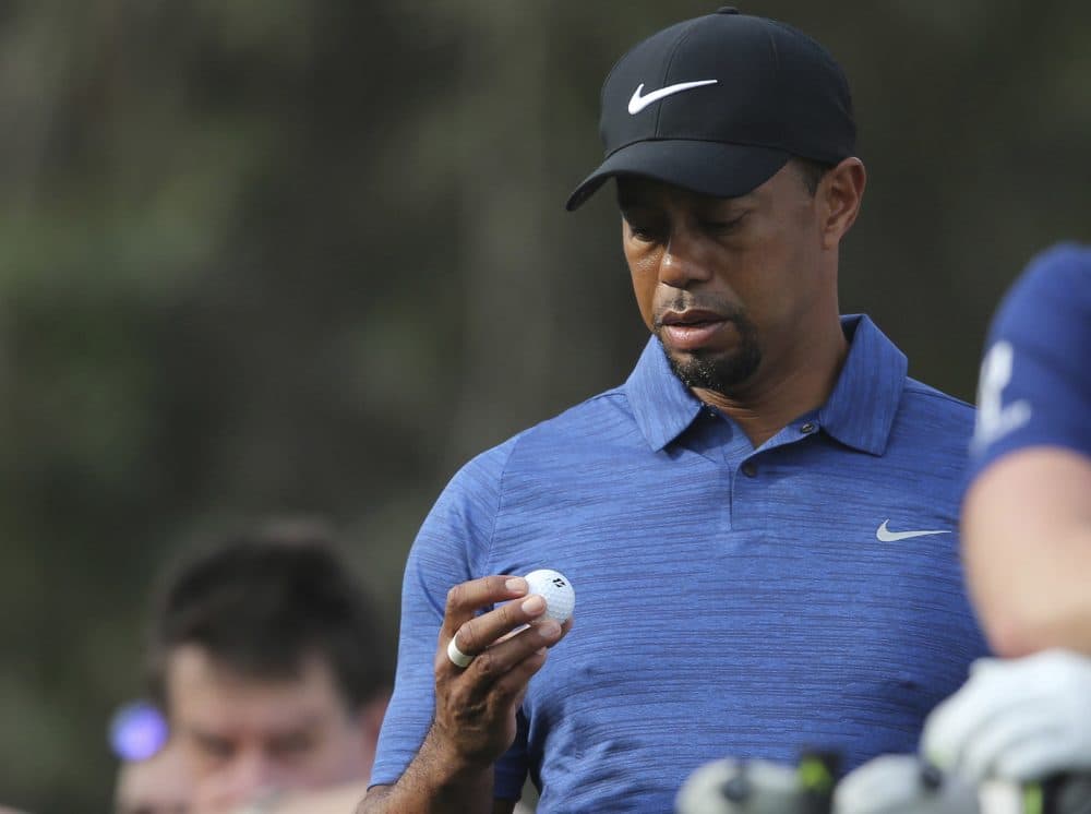 Tiger Woods reacts during the 1st round of the Dubai Desert Classic golf tournament in Dubai, United Arab Emirates. (Kamran Jebreili/AP)