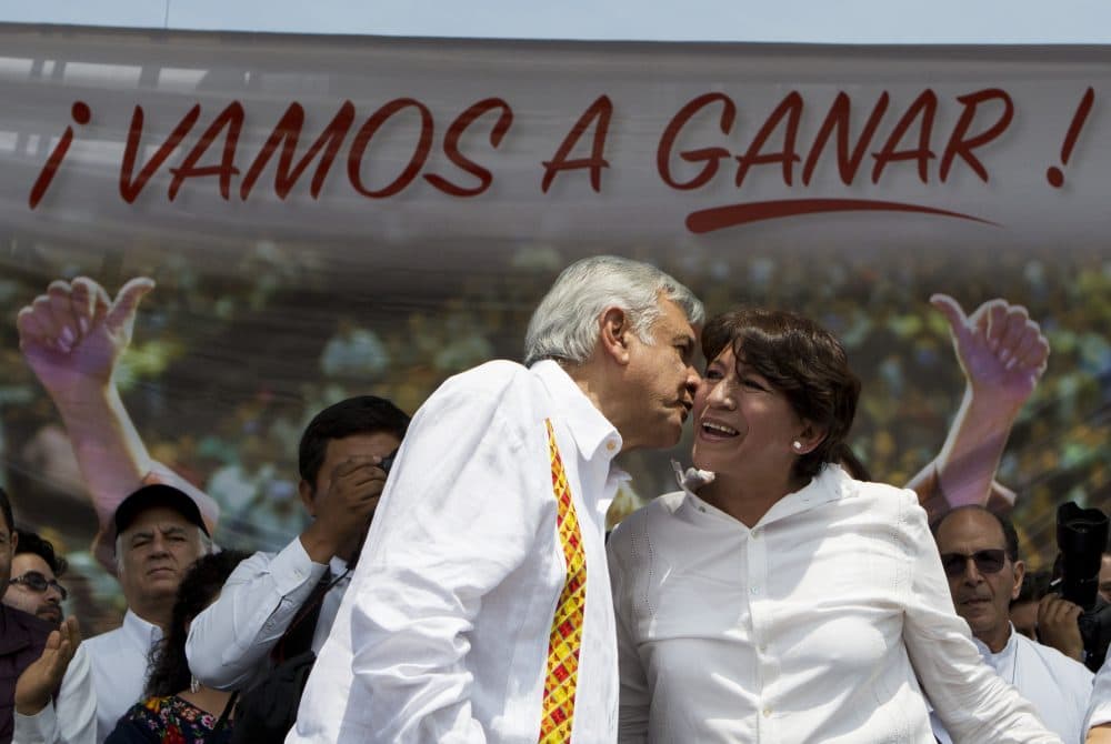 Presidential hopeful and two-time candidate Andres Manuel Lopez Obrador, left, speaks to Delfina Gomez, who is running for Mexico state governor with his National Regeneration Movement, or MORENA, under a banner reading in Spanish &quot;We are going to win,&quot; at a campaign rally in Nezahualcoyotl, Mexico state, Sunday, May 28, 2017. MORENA is attempting to unseat the ruling Institutional Revolutionary Party, known as the PRI, in June 4 gubernatorial elections in the state, one of the PRI's last remaining strongholds, where it has governed for 88 years. (Rebecca Blackwell/AP)