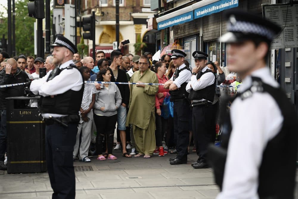 Members of the public view the scene after police officers raided a property in East Ham on June 4, 2017, in London. (Carl Court/Getty Images)