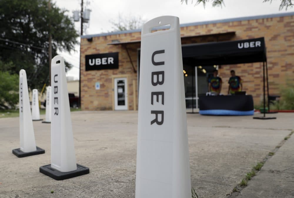 Workers set up in a tent to welcome drivers back to the Uber offices in Austin, Texas, in May. Uber and Lyft, the ride-hailing company giants who left Texas' capital city in a huff a year ago over local fingerprint requirements for drivers, are set to return after state lawmakers stepped in. (Eric Gay/AP)