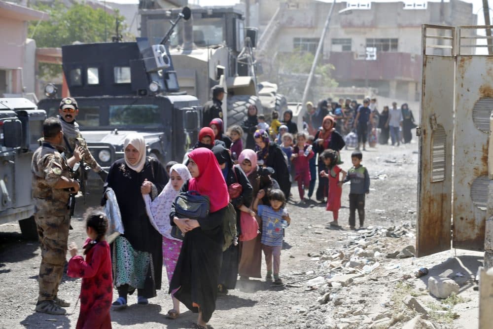 Iraqis leave the Zanjili neighbourhood in west Mosul on June 3, 2017, during the ongoing offensive by security forces to retake the city from Islamic State group fighters. (Karim Sahib/AFP/Getty Images)