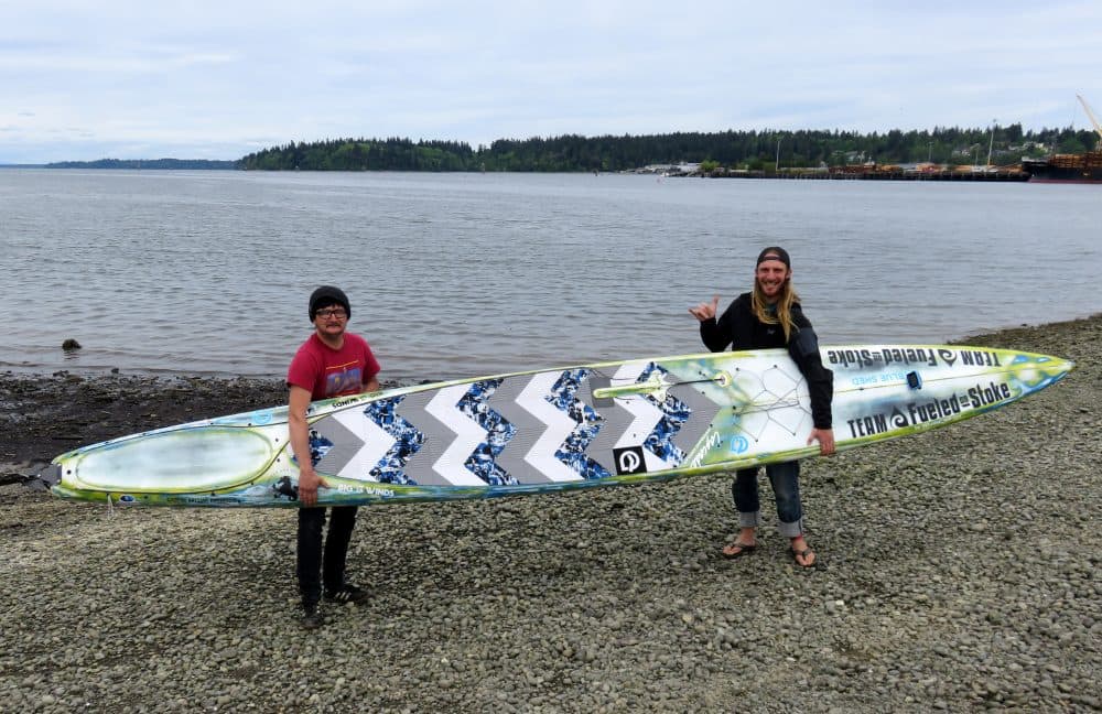 Erdogan Kirac, left, and Luke Burritt of Bellingham, Wash., are planning to compete in the Race to Alaska on twin boards, including this one. (Tom Banse/Northwest News Network)