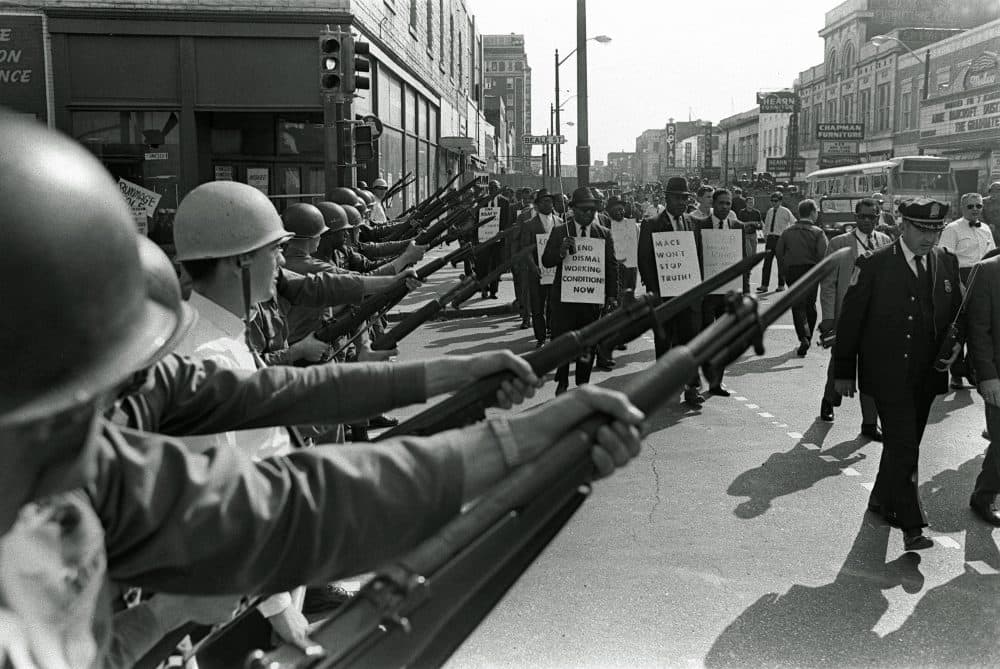 Striking Memphis sanitation workers march past Tennessee National Guard troops with fixed bayonets during a 20-block march to City Hall, March 29, 1968, one day after a similar march erupted in violence, leaving one person dead and several injured. (Charlie Kelly/AP)