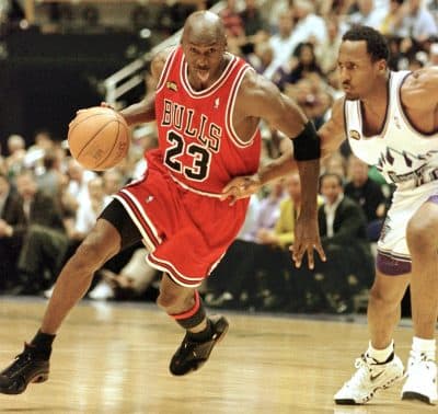 Michael Jordan of the Chicago Bulls sticks his tongue out and drives past Shandon Anderson of the Utah Jazz during Game 6 of the 1998 NBA Finals in Salt Lake City. (Mike Nelson/AFP/Getty Images)
