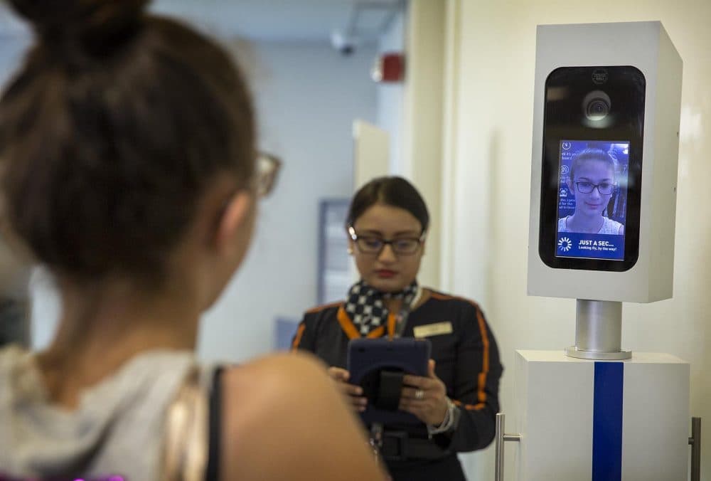 A passenger passes through a biometric scan before boarding a Jet Blue flight at Logan Airport, Boston. (Robin Lubbock/WBUR)