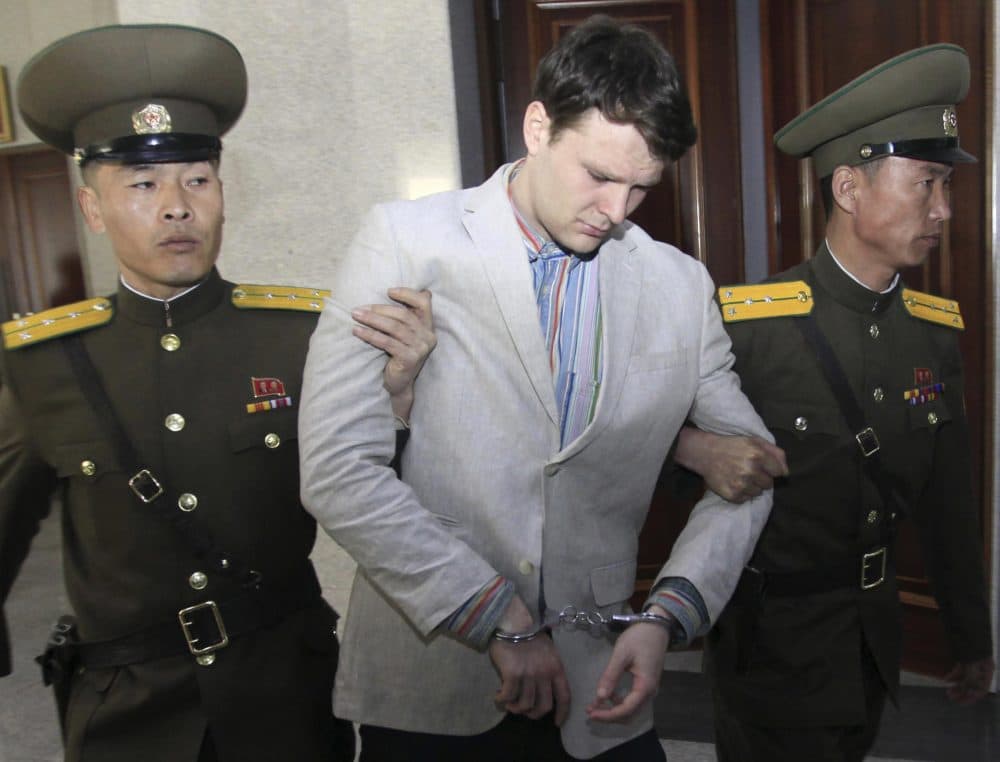 In this March 16, 2016, file photo, American student Otto Warmbier, center, is escorted at the Supreme Court in Pyongyang, North Korea. Warmbier, whose parents say has been in a coma while serving a 15-year prison term in North Korea, was released and returned to the United States Tuesday, June 13, 2017, as the Trump administration revealed a rare exchange with the reclusive country. (Jon Chol Jin/AP)