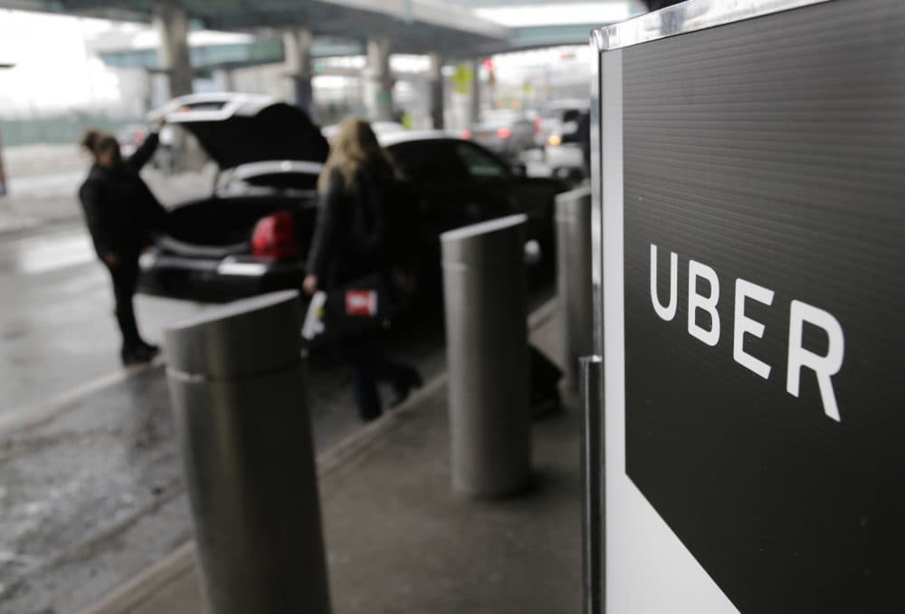 In this March 15, 2017, file photo, a sign marks a pick-up point for the Uber car service at LaGuardia Airport in New York. Travis Kalanick, the combative and embattled CEO of ride-hailing giant Uber, resigned under pressure from investors at a pivotal time for the company. (Seth Wenig/AP)