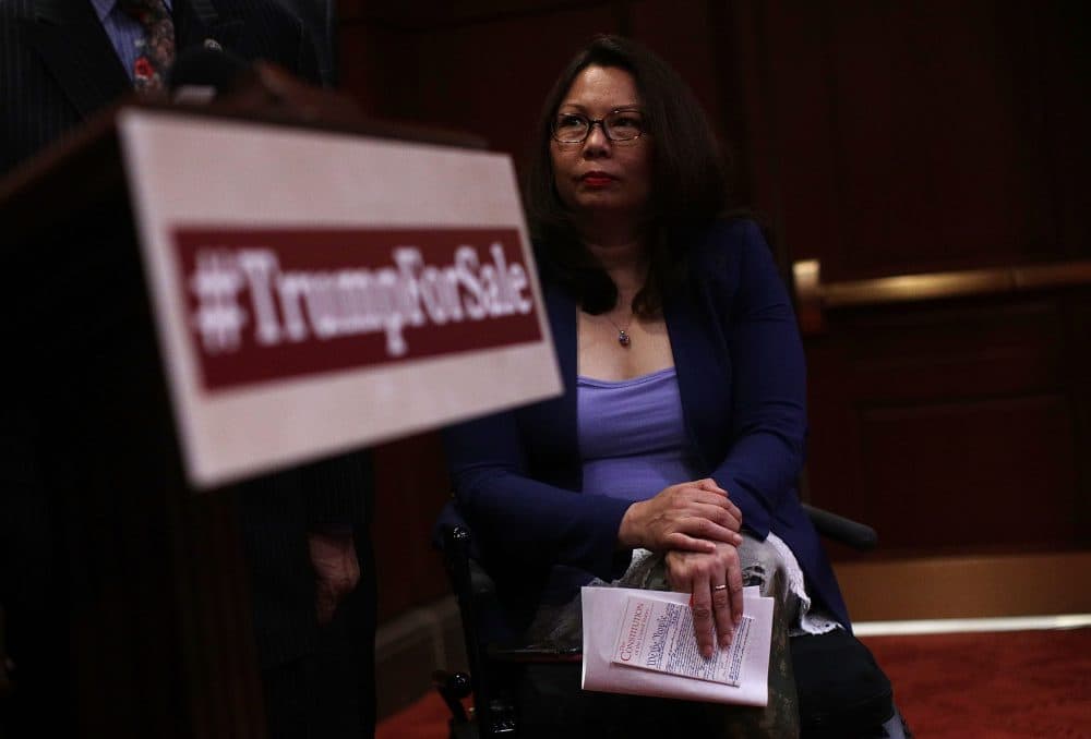 Sen. Tammy Duckworth (D-Ill.) holds a copy of the Constitution as she listens during a news conference June 20, 2017 on Capitol Hill in Washington, D.C. (Alex Wong/Getty Images)