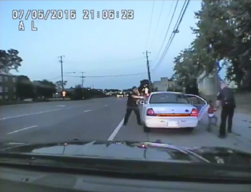 In this image made from July 6, 2016, video captured by a camera in the squad car of St. Anthony Police officer Jeronimo Yanez, the Minnesota police officer is shown after shooting into the vehicle at Philando Castile during a traffic stop in Falcon Heights, Minn., as the 4-year-old daughter of Castile's girlfriend, Diamond Reynolds, starts to get out of the car and is grabbed by an officer. (St. Anthony Police Department via AP)