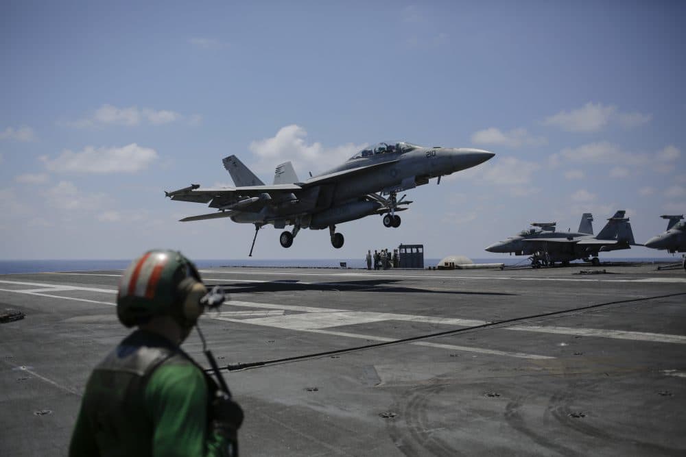 A fighter jet lands on the USS George H.W. Bush aircraft carrier on Thursday, June 22, 2017 in the Mediterranean Sea. F18 fighter jets launch multiple times a day from the carrier bombing the Islamic State positions in Iraq and Syria. (Bram Janssen/AP)