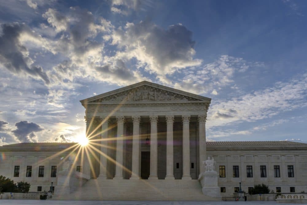 The sun rises behind the U.S. Supreme Court building in Washington on Sunday. (J. David Ake/AP)