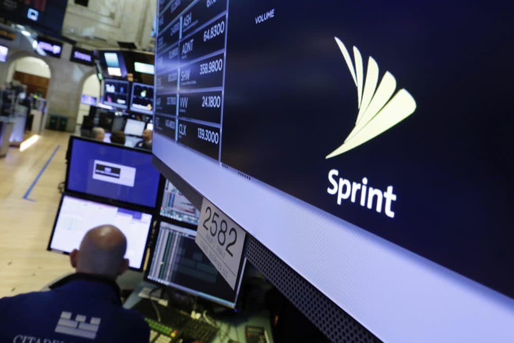 The Sprint logo appears above a trading post on the floor of the New York Stock Exchange, Tuesday, June 27, 2017. Sprint climbed 5.8 percent following a published report suggesting the mobile phone company is in talks with Charter Communications and Comcast Corp. on a deal that could enable the cable operators to buy a stake in Sprint. (Richard Drew/AP)