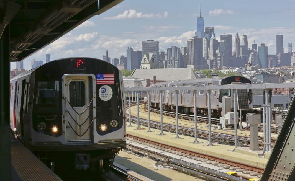Subway trains at Brooklyn's Smith Street station travel above ground against a backdrop of the Manhattan skyline, Wednesday June 21, 2017, in New York. Subway riders are frustrated by power outages, signal problems and other breakdowns with the number of train delays tripled in five years. (Bebeto Matthews/AP)
