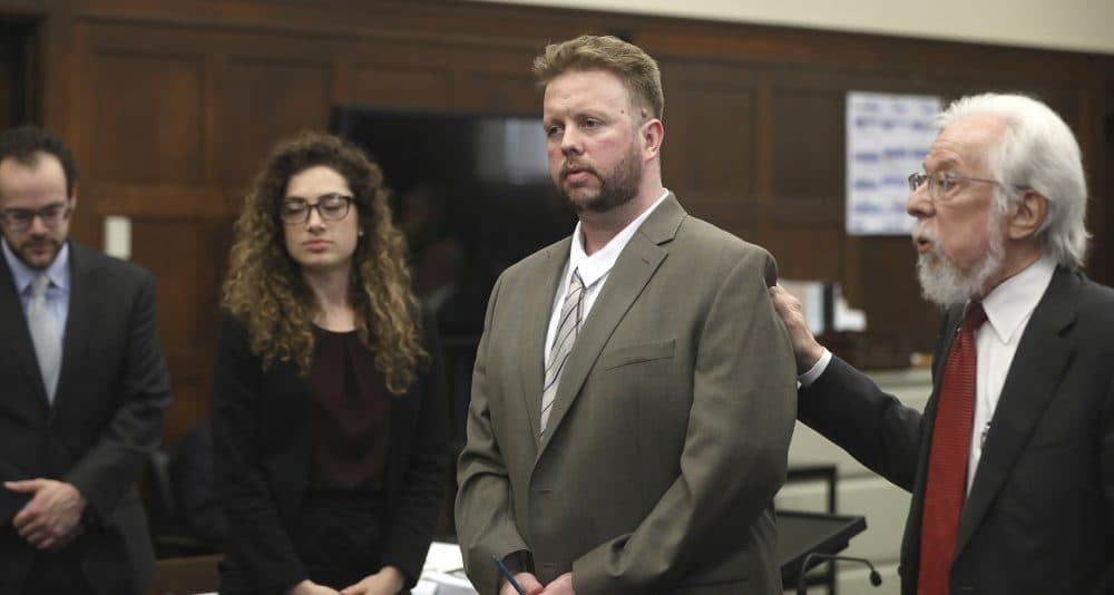 Defense attorney Jonathan Shapiro, right, introduces Michael McCarthy, second right, to potential jurors as jury selection begins for McCarthy's murder trial last month. (Pat Greenhouse/The Boston Globe via AP, Pool)