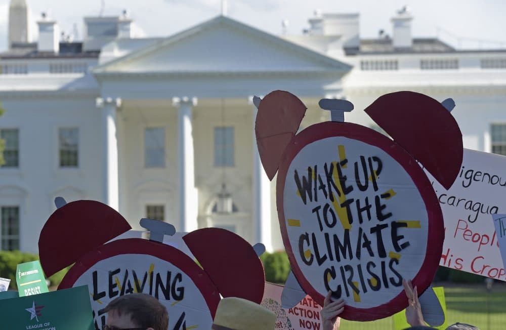 Protesters gather outside the White House in Washington, Thursday, June 1, 2017, to protest President Donald Trump's decision to withdraw the Unites States from the Paris climate change accord. (Susan Walsh/AP)