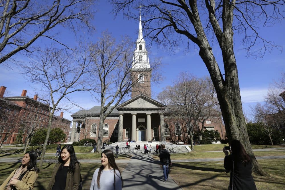 In this March 13, 2016 photo, people walk near Memorial Church on the campus of Harvard University in Cambridge, Mass. (Steven Senne/ AP)