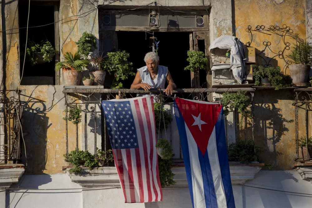 Javier Yanez stands on his balcony decorated with U.S. and Cuban flags in Old Havana, Cuba on Dec. 19, 2014. (Ramon Espinosa/AP)