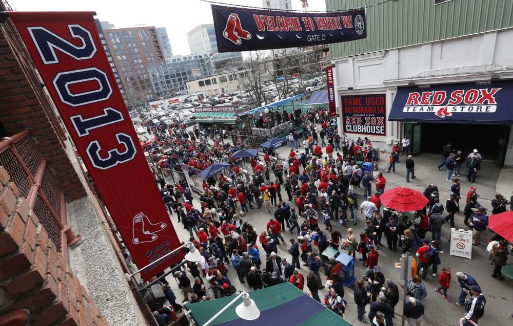 Fans enter Fenway Park on Yawkey Way before the Boston Red Sox home opener, Friday, April 4, 2014. (Michael Dwyer/AP)