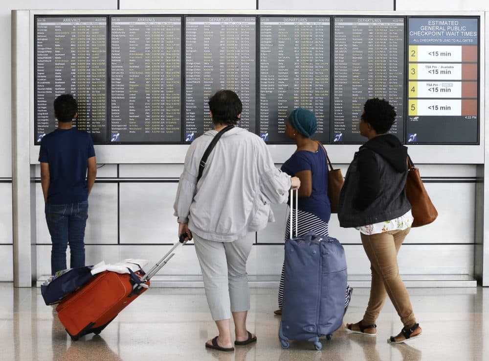 The Supreme Court partially reinstated Trump's travel ban, Google fined $2.7 billion for antitrust violations and Logan TSA agents spot a lobster. All that and more from Tom Keane's weekly news roundup. Pictured: Travelers check arrival and departure information on a signboard at the Seattle-Tacoma International Airport, Monday, June 26, 2017. (Ted S. Warren/AP)