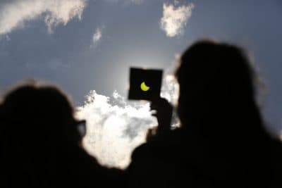 A solar eclipse is seen through a dark glass plate in Sarajevo, Bosnia , on Friday , March 20, 2015. (Amel Emric/AP)