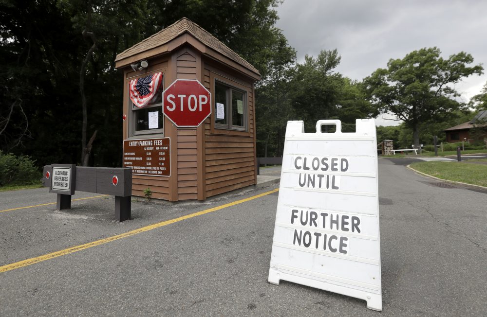 A sign sits at the entrance of Cheesequake State Park, which remains closed due to the New Jersey government shutdown, Saturday, July 1, 2017, in Matawan, N.J. (AP Photo/Julio Cortez)