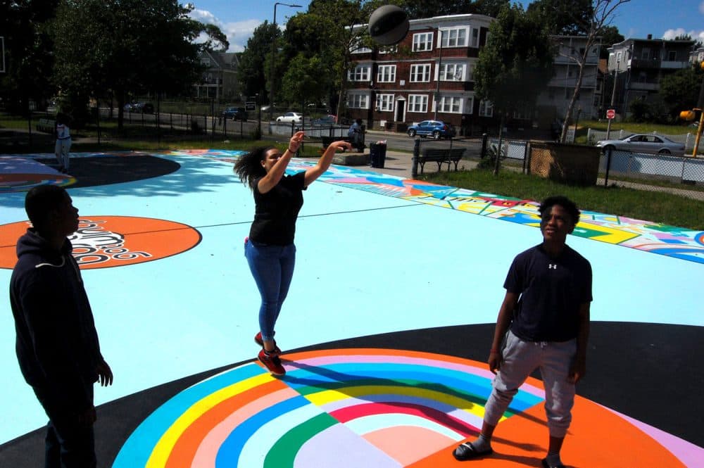 Playing on Maria Molteni's &quot;Hard In the Paint&quot; basketball court mural at Boston's Harambee Park. (Greg Cook/WBUR)