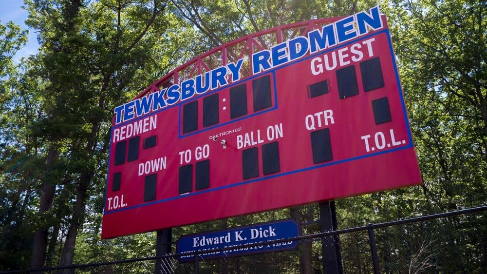 A group of citizens have proposed banning native-themed mascots at Massachusetts schools, but the state's native residents are divided -- sometimes pitting the young against their elders. Here, the scoreboard is seen at Tewksbury Memorial High School's athletic fields, the home of the so-called Redmen. (Max Larkin/WBUR)