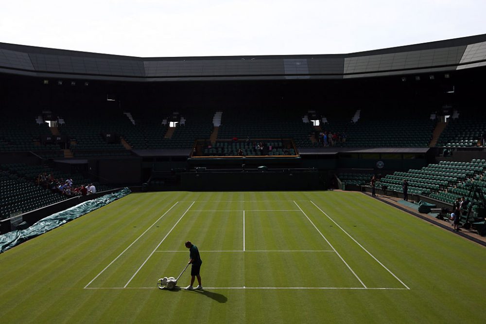 A groundsman paints a line on Centre Court on on Day 1 of Wimbledon tennis tournament on June 29, 2015 in London, England. (Carl Court/Getty Images)