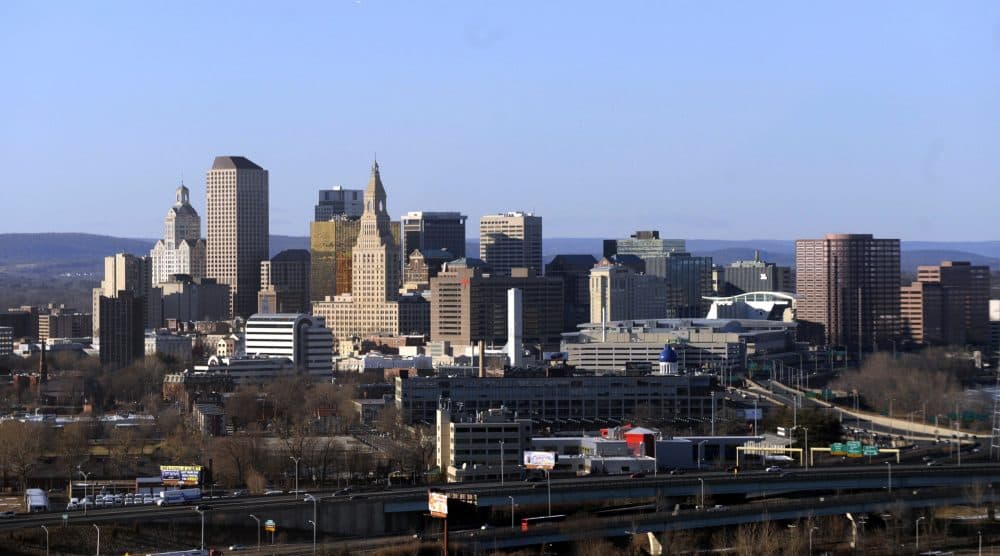 In this Feb. 7, 2010 aerial file photo, the skyline of Hartford, Conn., rises on the west bank of the Connecticut River. The struggling capital city is trying to persuade lawmakers to provide $40 million more in 2017 from the state's cash-strapped coffers to help offset a projected $65 million deficit in 2018. (Jessica Hill/AP)