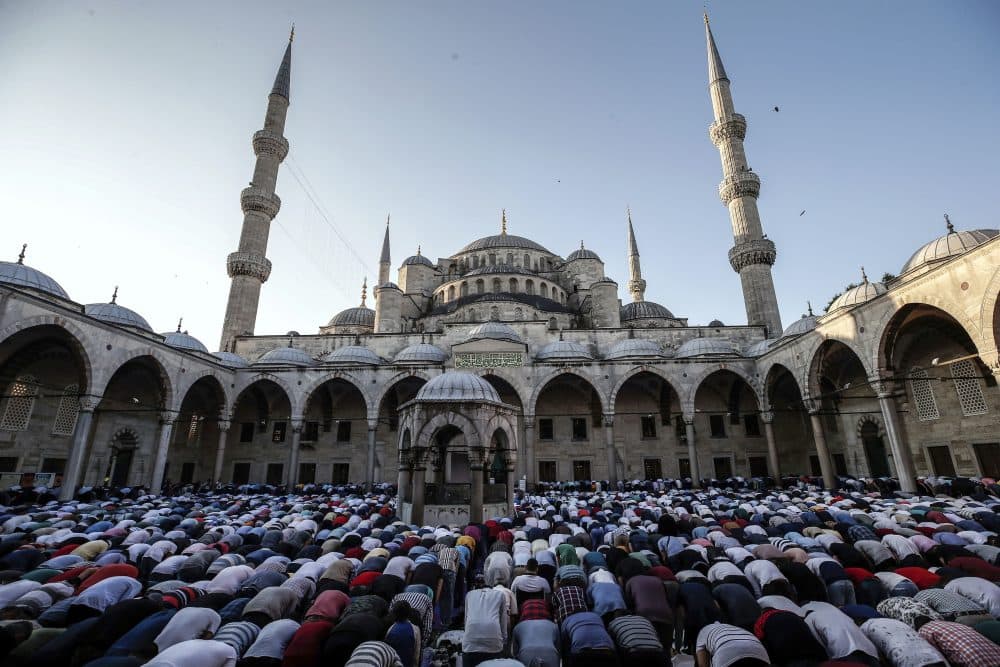 Turkish Muslims offer Eid al-Fitr prayers at the city's landmark Sultan Ahmed Mosque, or Blue Mosque, in Istanbul, early Sunday, June 25, 2017. Eid al-Fitr marks the end of the Muslims' holy fasting month of Ramadan. (Emrah Gurel/AP)
