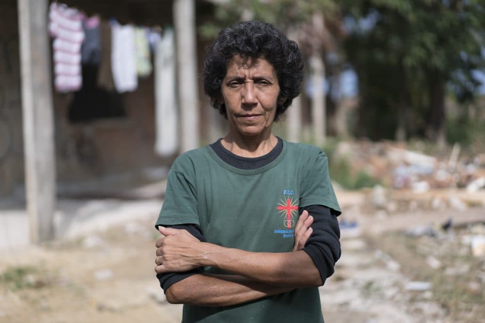 In this June 3, 2016 photo, Maria da Penha, a resident of the Vila Autódromo favela located next to Olympic Park, poses for a portrait in Rio de Janeiro, Brazil. Penha's home in a favela abutting the Olympic Park, known at Vila Autodromo, was demolished to make way for new construction. “For me the Olympics were awful,” said the 51-year-old, who led a year-long eminent-domain battle against Rio Mayor Eduardo Paes. “They destroyed my life, my dream. I had my own house and I won't have it anymore.” (Renata Brito/AP)