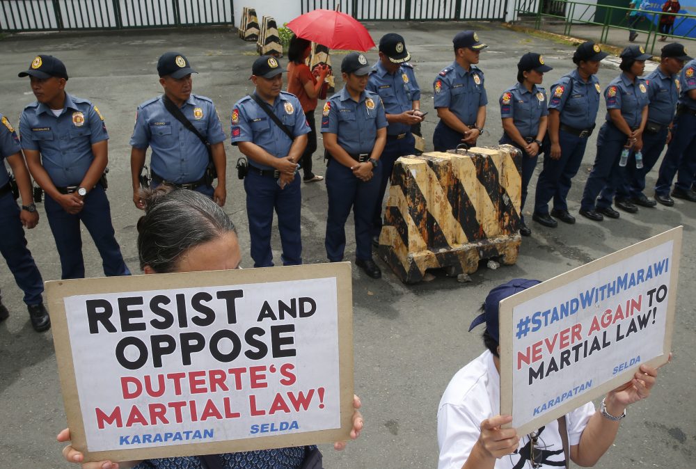 Protesters display placards during a rally outside Camp Aguinaldo, the general headquarters of the Armed Forces of the Philippines, to protest the extension of Martial Law in the whole of Mindanao island in the southern Philippines as proposed by President Rodrigo Duterte, Thursday, July 20, 2017 in Quezon city northeast of Manila, Philippines. (Bullit Marquez/AP)