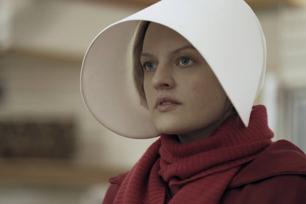 This image released by Hulu shows Elisabeth Moss as Offred in a scene from, &quot;The Handmaid's Tale.&quot; Moss was nominated for an Emmy Award for outstanding lead actress in a drama series on Thursday, July 13, 2017. (George Kraychyk/Hulu via AP)