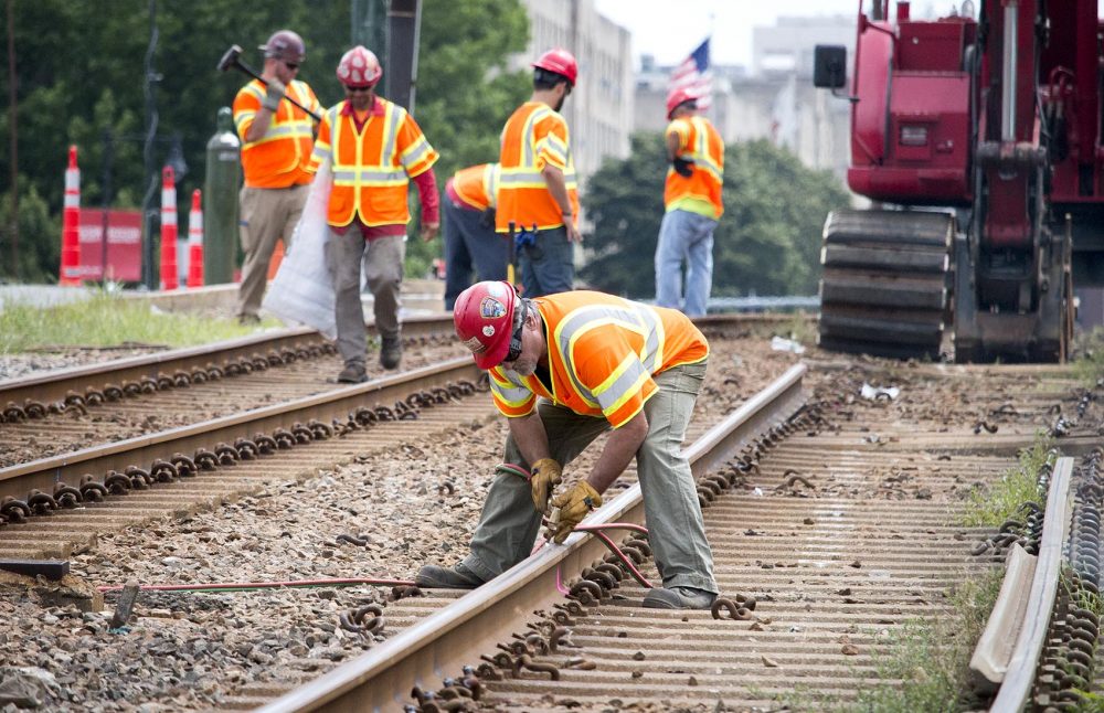 MBTA staff remove tracks along Commonwealth Ave. (Kathleen Dubos for WBUR)