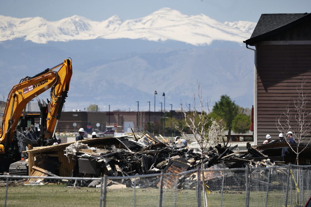 Workers dismantle the charred remains of a house at the location where an unrefined petroleum industry gas line leak explosion killed two people inside their home, in Firestone, Colo., Thursday, May 4, 2017. (Brennan Linsley/AP)