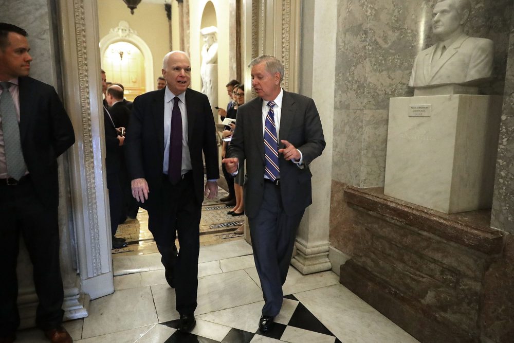 U.S. Sen. John McCain (R-Ariz.) (left), who was recently diagnosed with brain cancer, and Sen. Lindsey Graham (R-S.C.) head for the Senate Floor for a vote at the U.S. Capitol July 26, 2017 in Washington. (Chip Somodevilla/Getty Images)