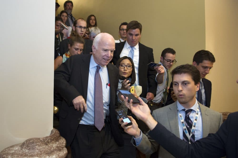 Sen. John McCain, R-Az., front left, is pursued by reporters after casting a &quot;no&quot; vote on a measure to repeal parts of former President Barack Obama's health care law, on Capitol Hill in Washington, Friday, July 28, 2017. (Cliff Owen/AP)