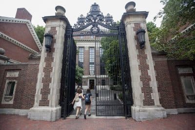 Students enter a side gate at Harvard University (Joe Difazio/WBUR)