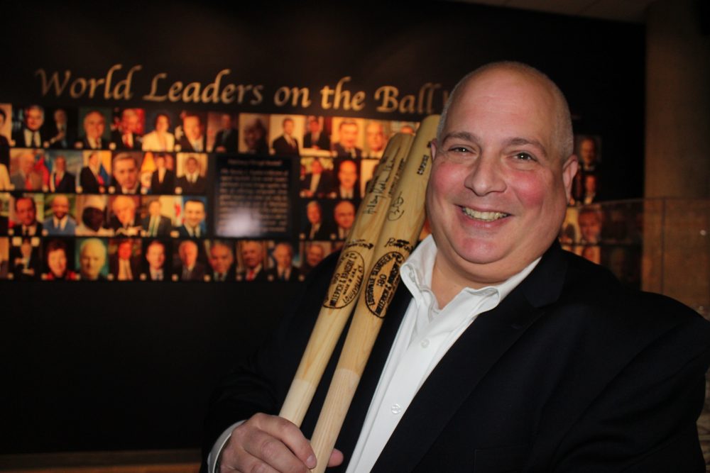 Randy Kaplan spends 20 to 30 hours a week researching world leaders and prospective world leaders. Here he holds autographed baseball bats signed by former President Barack Obama and Hillary Clinton. (Frank Eltman/AP)