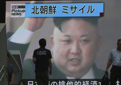 In this Tuesday, July 4, 2017 photo, people walk in front of an image of North Korean leader Kim Jong Un shown on a large screen as a TV news reports the North Korea's missile test which landed in the waters of Japan's economic zone, in Tokyo. Despite U.S. President Donald Trump's hopes for China's help in dealing with North Korea and his recent tough talk on the matter, the two sides seem to be growing further apart as their approaches and concerns diverge. China shows no sign of caving in to U.S. pressure to tighten the screws on North Korea, while the North's recent missile tests have done little to rattle Beijing. China's bottom line continues to hold: no to any measures that might topple Kim Jong Un's hard-line communist regime. The top banner reads: &quot;North Korea Missile.&quot; (Eugene Hoshiko/AP)