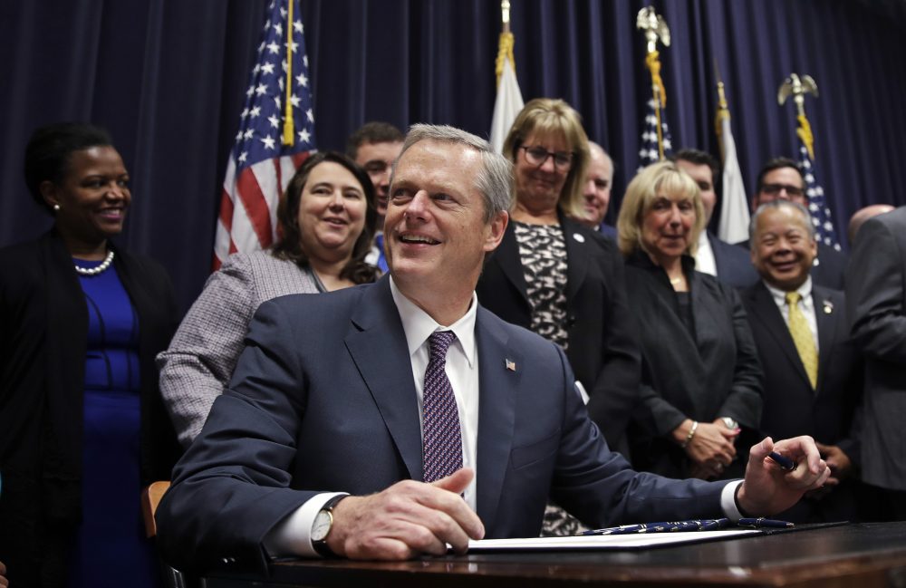 Gov. Charlie Baker pauses as he signs into law the Pregnant Workers Fairness Act during a ceremony at the State House Thursday, July 27, 2017. (Charles Krupa/AP)