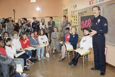 First Lady Nancy Reagan sits with students at Rosewood Elementary School in Los Angeles in February 1987 as they listen to a DARE presentation by a Los Angeles police officer. (Nick Ut/AP)