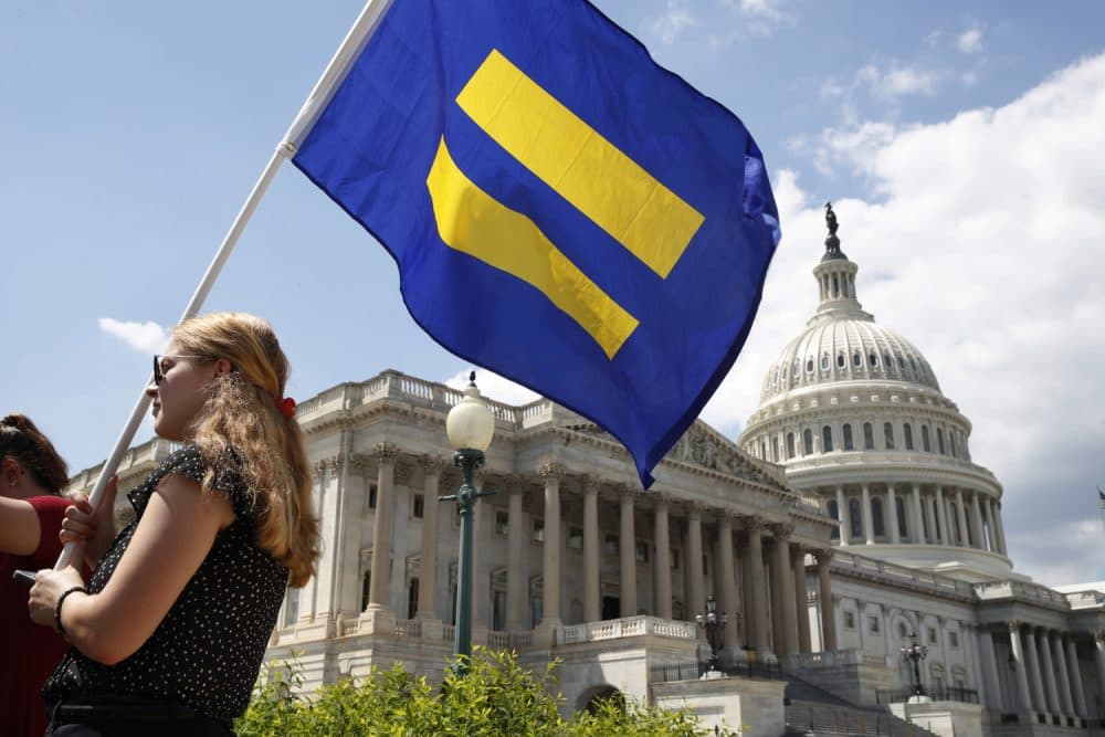 A supporter of LGBT rights holds up an &quot;equality flag&quot; on Capitol Hill on Wednesday. (Jacquelyn Martin/AP)